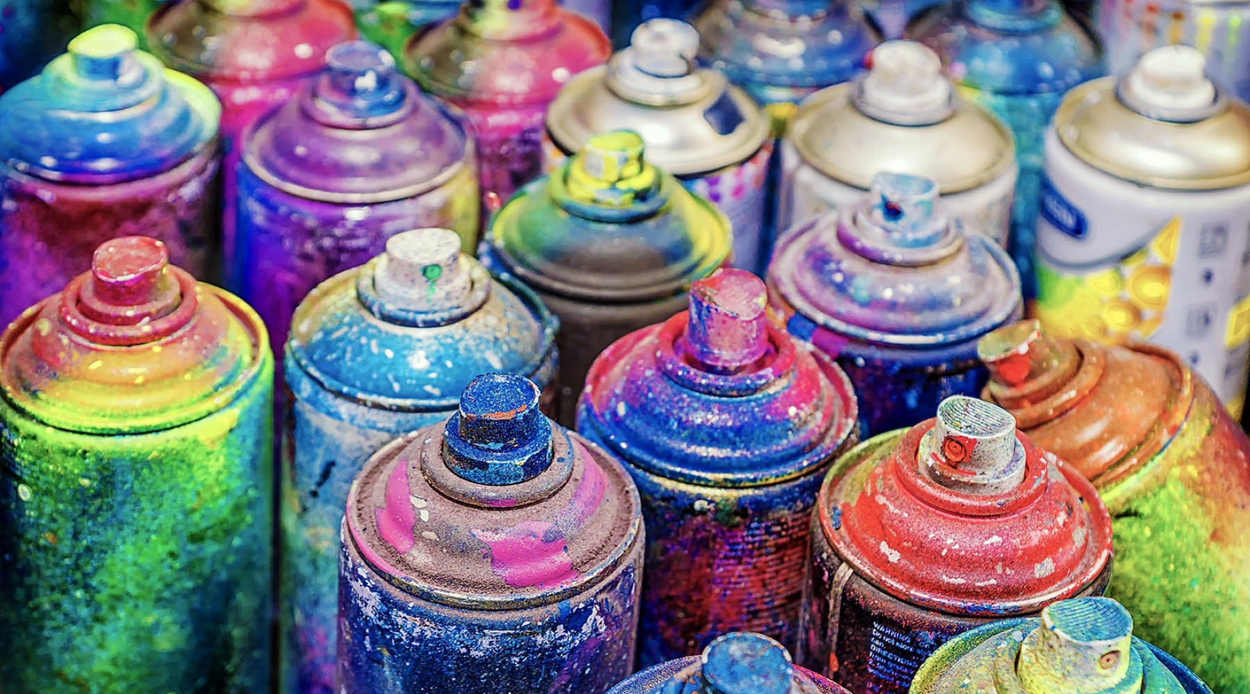 multi-colored painted cans of spray paints